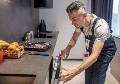 man-looking-information-control-panel-dishwasher_259150-58285