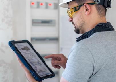 electrical-technician-looking-focused-while-working-switchboard-with-fuses_169016-23714