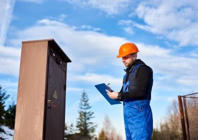 oil-inspector-protective-overalls-orange-helmet-making-notes-transformer_651396-1818